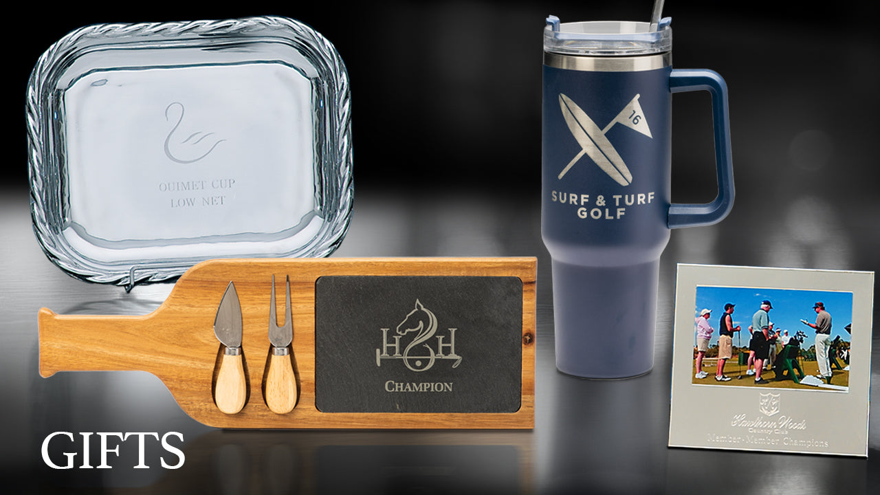 A selection of gifts including a glass tray, insulated travel mug, cheese board with utensils, and a framed photo of golfers, displayed on a black background. The word GIFTS appears in the bottom left corner.
