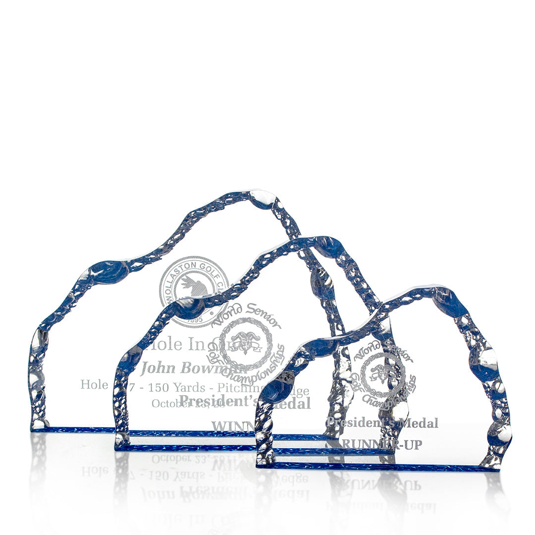 Three Acrylic Blue Iceburg trophies by Prize Possessions with blue, wavy edges are displayed in a row. Each features engravings with a golf logo and award details—ideal for winners or runner-ups at corporate events.