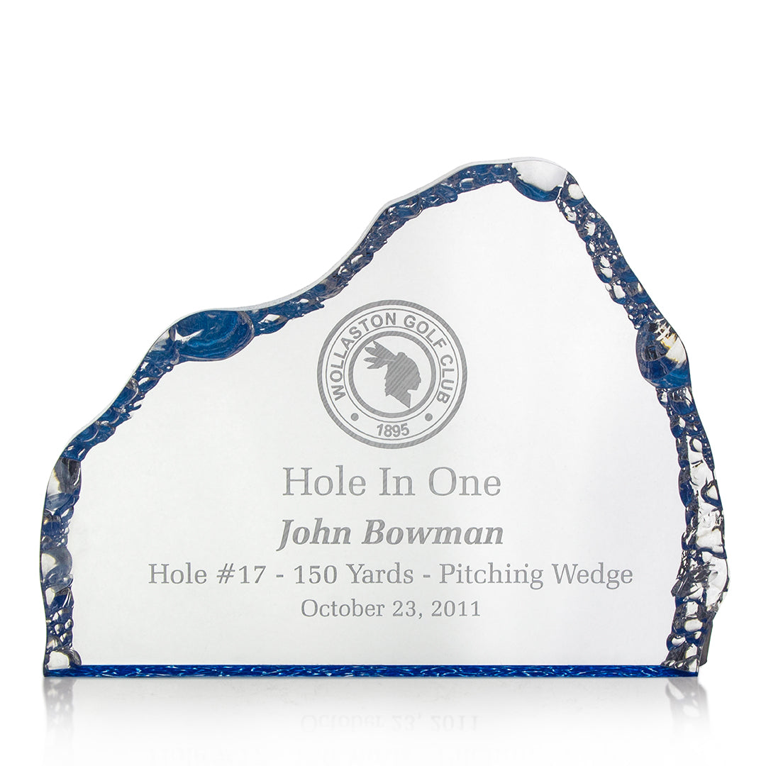 The Acrylic Blue Iceburg by Prize Possessions is a clear glass golf award plaque with blue edges, featuring the Wollaston Golf Club logo and engraved: Hole In One, John Bowman, Hole #17 – 150 Yards – Pitching Wedge, October 23, 2011.
