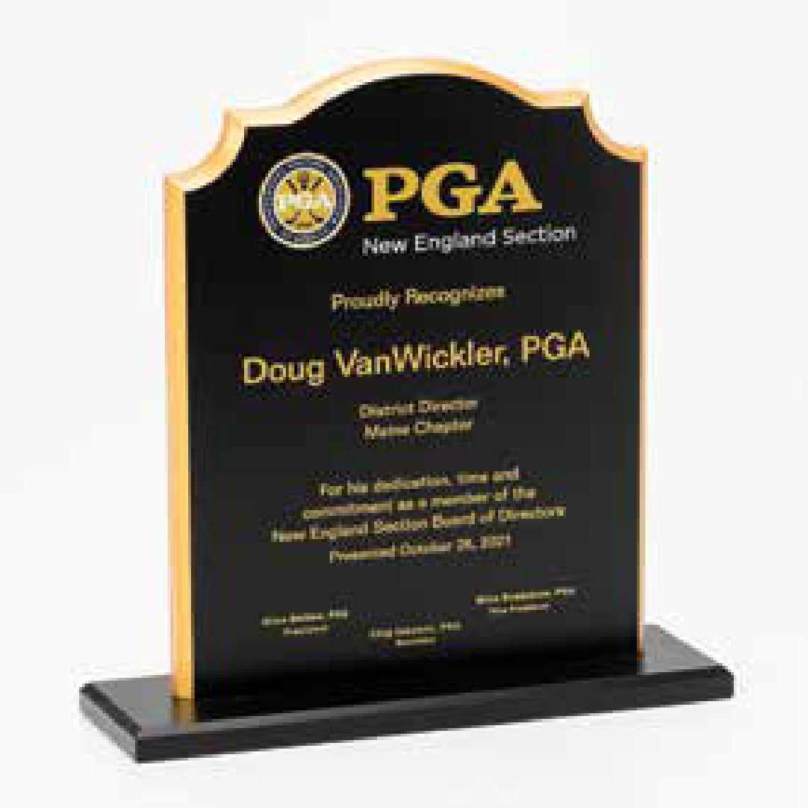 The Prize Possessions Black Notched Plaque, presented to Doug VanWickler by the PGA New England Section for service as District Director of the Maine Chapter, serves as an elegant commemorative display on a black base.