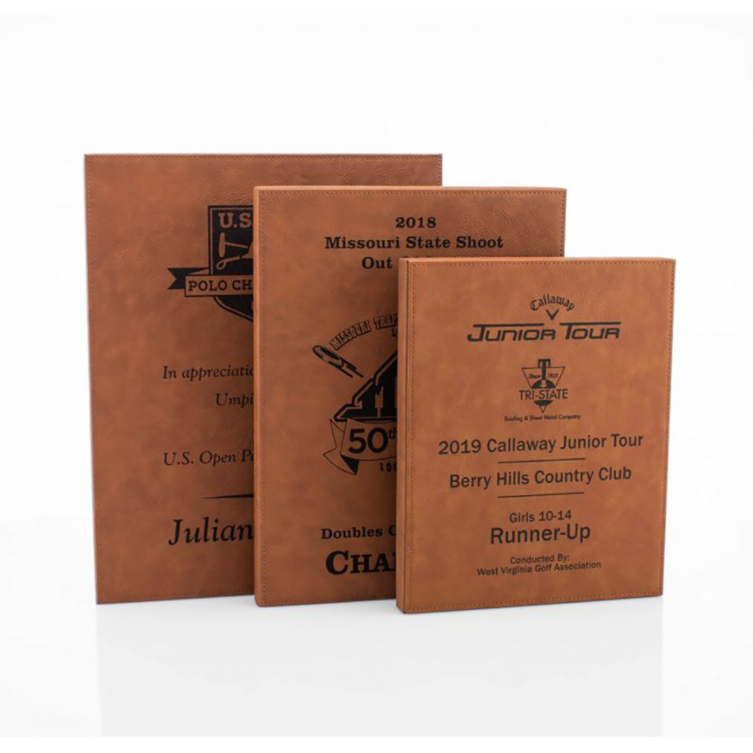 The Prize Possessions Caramel Leatherette Plaque features a smooth finish and stands upright in various sizes, engraved with custom award titles, logos, and recipient information—ideal for sports achievements or office recognition.