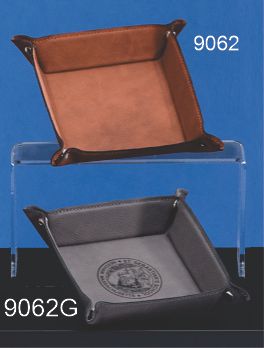 Two Caramel Leatherette Snap Trays by Prize Possessions are displayed as catchall desk organizers against a blue and black background, featuring one plain brown and one black tray with a circular embossed logo inside.
