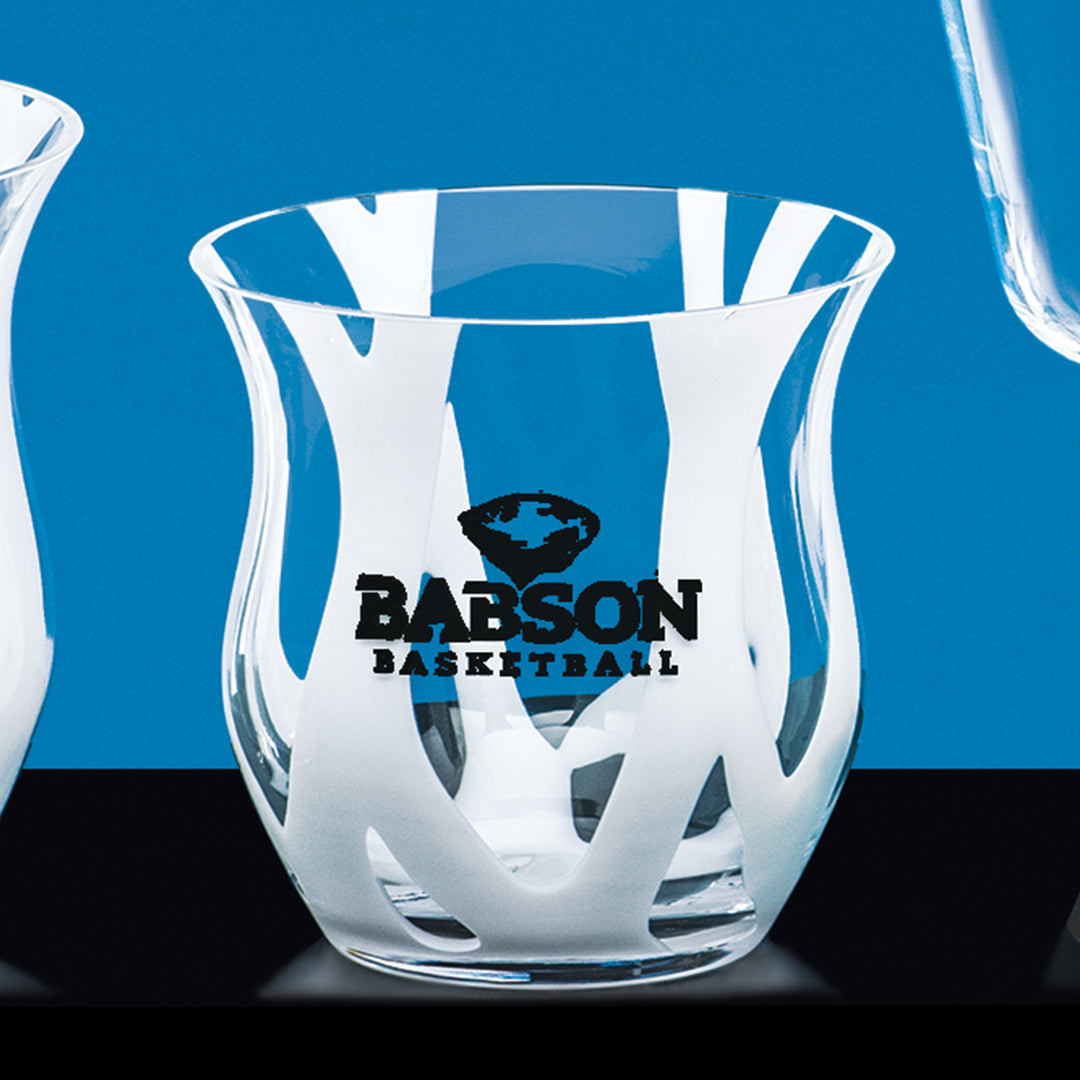 A Clear Bowl with White Wave by Prize Possessions featuring white abstract patterns and "Babson Basketball" in black on the front, displayed against a blue background.