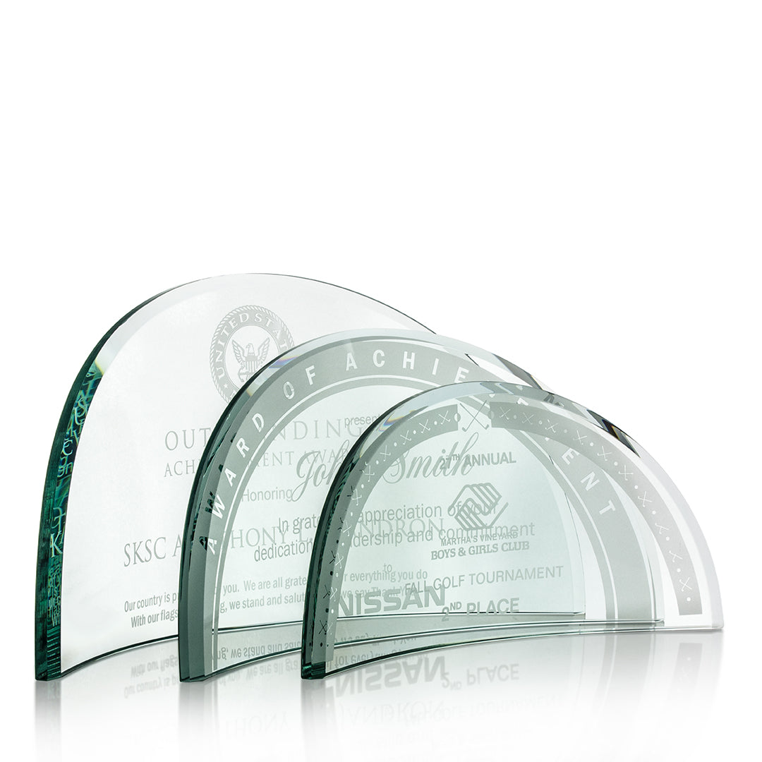 Three Crystal Beveled Arch Awards by Prize Possessions, in ascending sizes with engraved text and logos, are arranged side by side on a white background. These semi-circular awards feature a sleek flat base—ideal for corporate recognition.