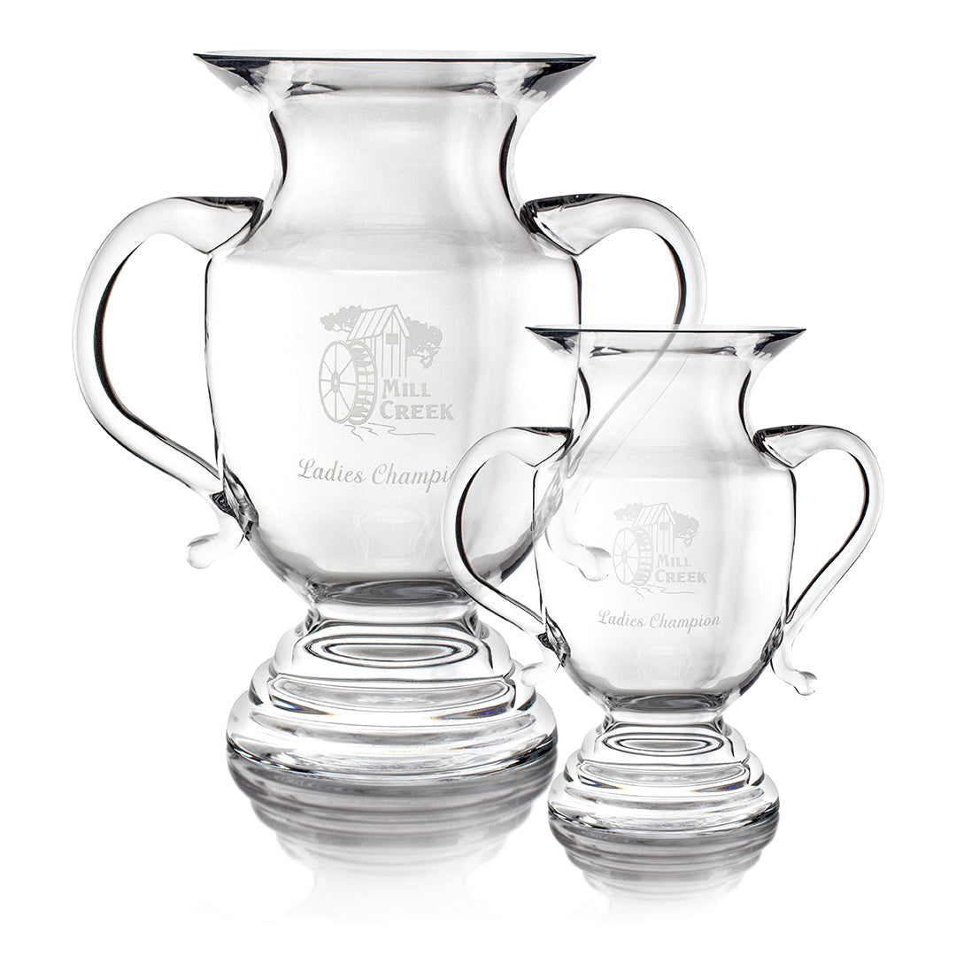 Two clear Crystal Darlington Vases by Prize Possessions, engraved with Mill Creek Ladies Champion and a watermill image. One is larger; both stand side by side, making elegant centerpieces for flowers or display.
