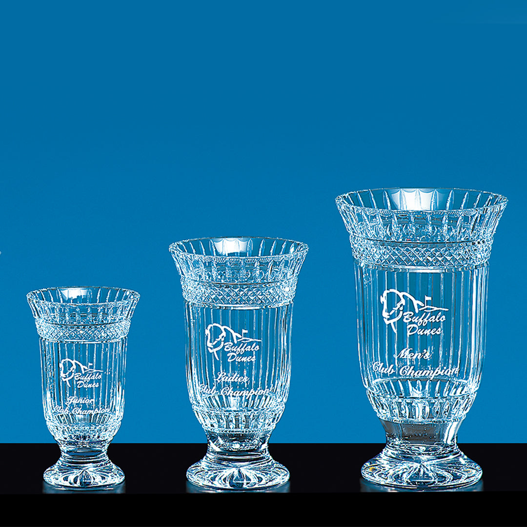 Three clear Crystal Kilmore Awards by Prize Possessions, each intricately engraved with “Buffalo Downs” and horse racing motifs, are displayed side by side against a blue background.