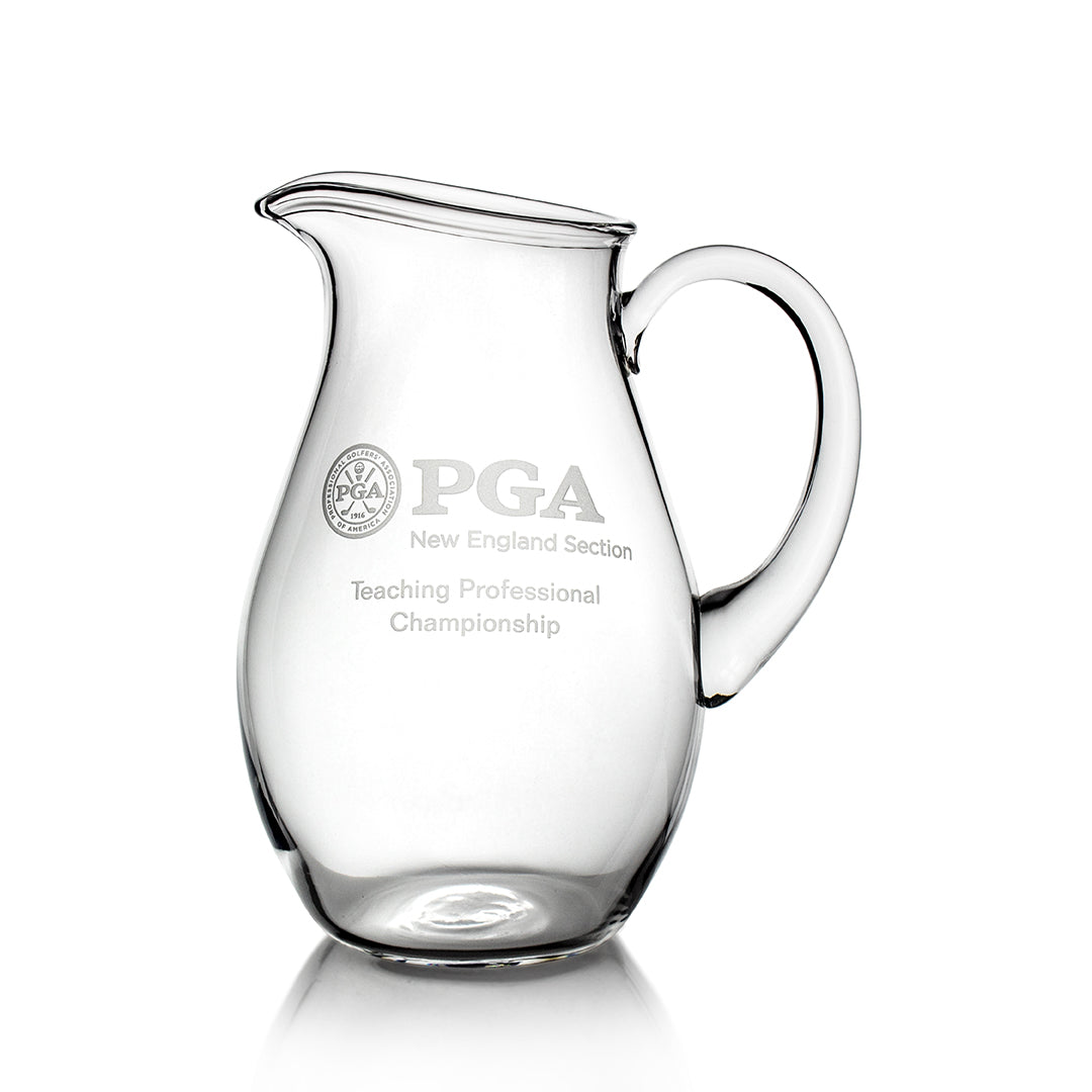 The Prize Possessions Crystal Pitcher features an engraved PGA New England Section Teaching Professional Championship logo and text on the front, making it a stylish way to serve beverages.