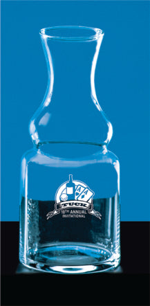 The Prize Possessions Crystal Wine Carafe features a logo and "10th Annual Invitational" text on the front, displayed against a blue background with a black surface underneath.