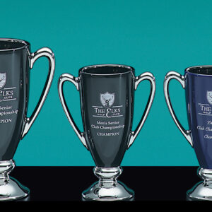 Three Ebony Ceramic Cups by Prize Possessions, featuring decorative handles and engraved plaques, are displayed against a teal background. Their sleek design evokes minimalist ceramics and marks them as club championship awards.