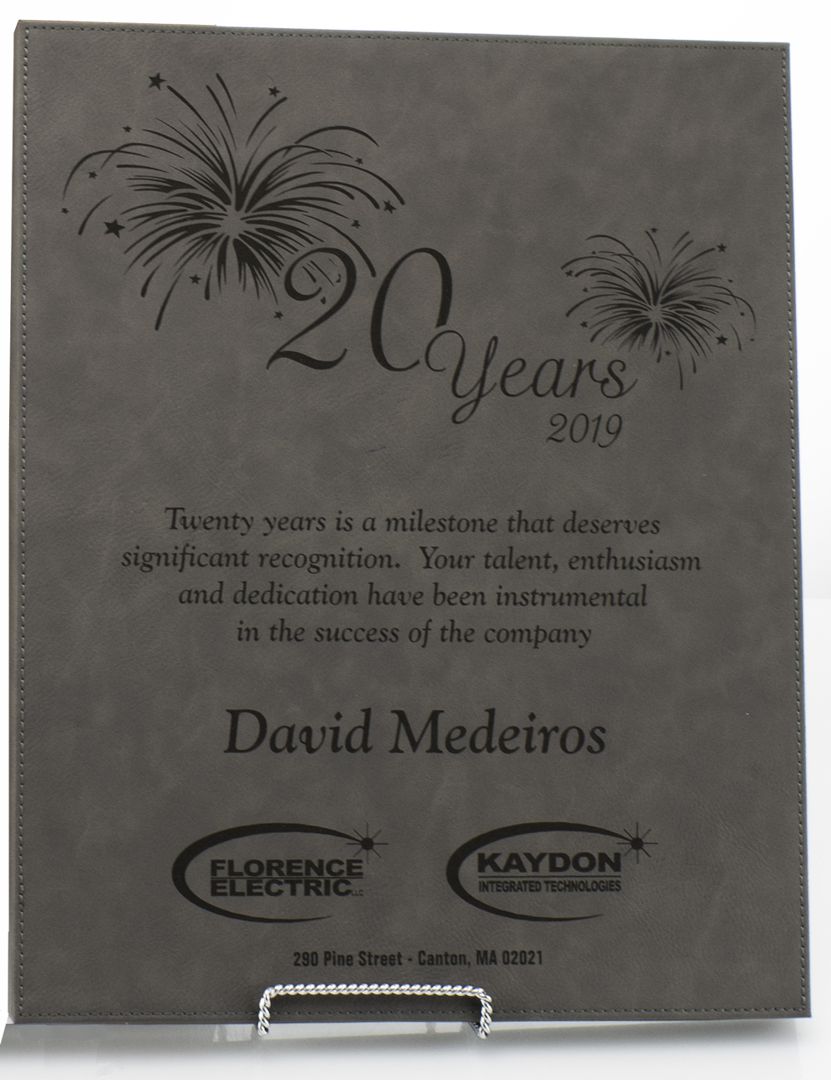 The Prize Possessions Grey Leatherette Plaque features fireworks graphics and "20 Years 2019," recognizing David Medeiros’s 20 years of dedication, with Florence Electric and Kaydon Integrated Technologies logos at the bottom.