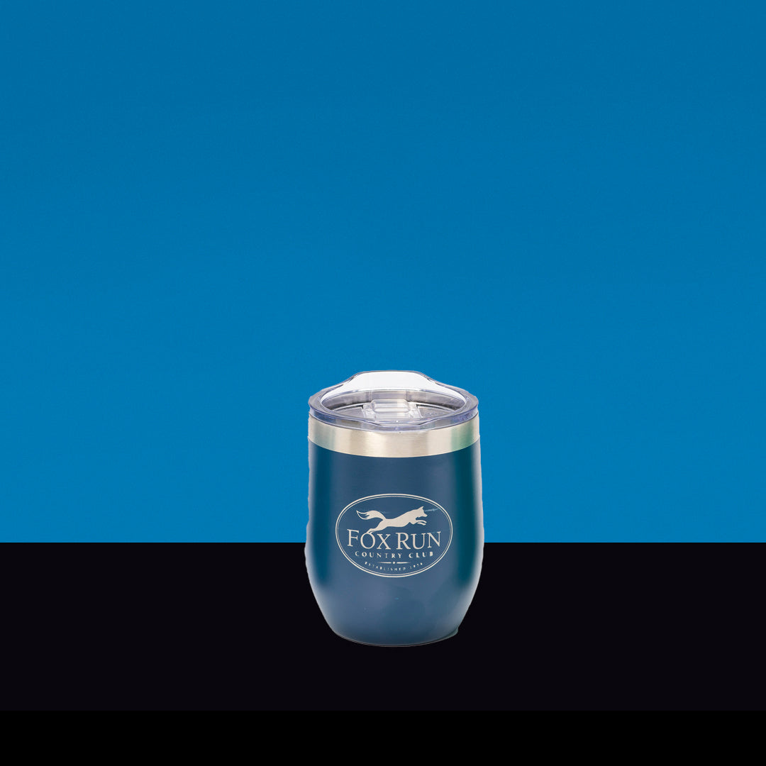 A Navy Blue Wine Tumbler by Prize Possessions with a clear lid is centered on a blue and black background, displaying a fox logo and white text—ideal as your favorite outdoor wine glass.