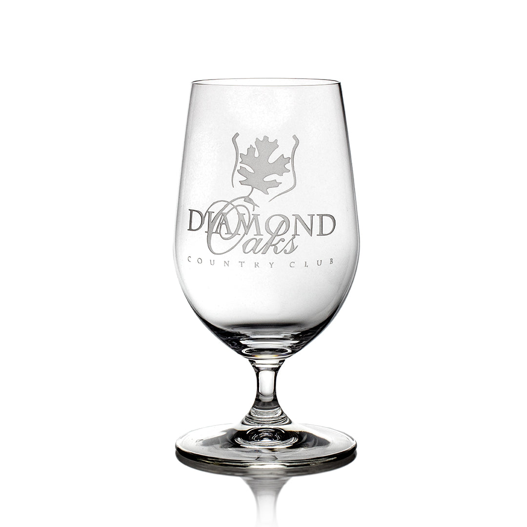 A Riedel Beer Glass by Prize Possessions, featuring the Diamond Oaks Country Club logo and a leaf design etched on the front, displayed against a white background.