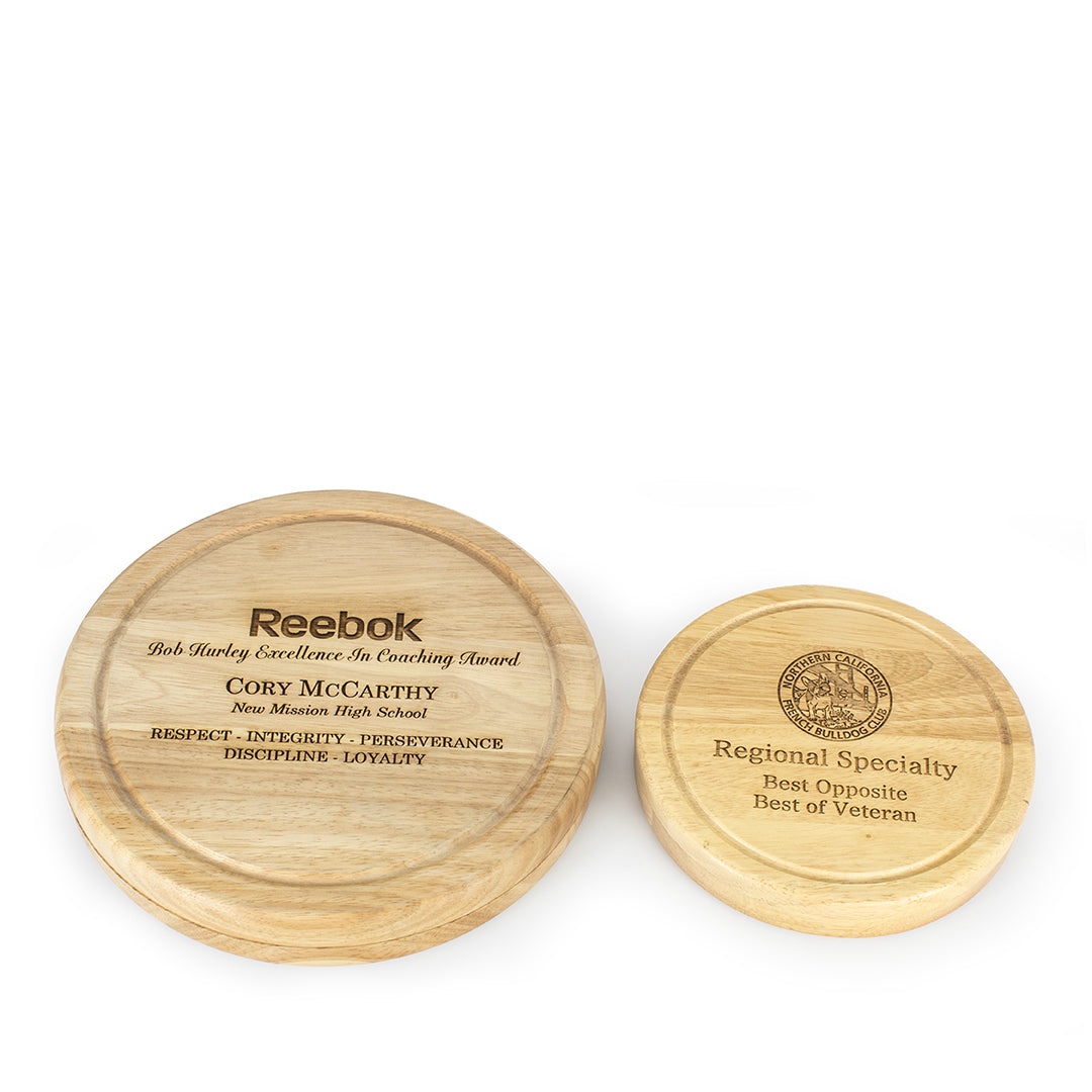 Two Prize Possessions Round Wood Cheese Boards with Tools sit side by side; the larger honors Cory McCarthy’s coaching, while the smaller recognizes regional specialty, best opposite, and best of veteran achievements.