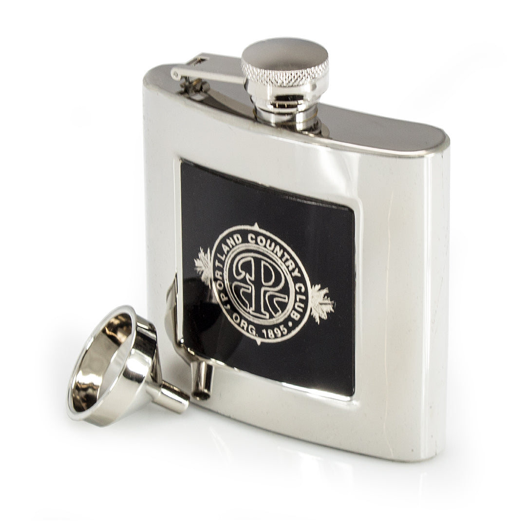 The Prize Possessions Silverplate Flask features a screw cap and a black emblem on the front reading "Portland Country Club 1895." A stylish piece to add to your barware accessories collection.