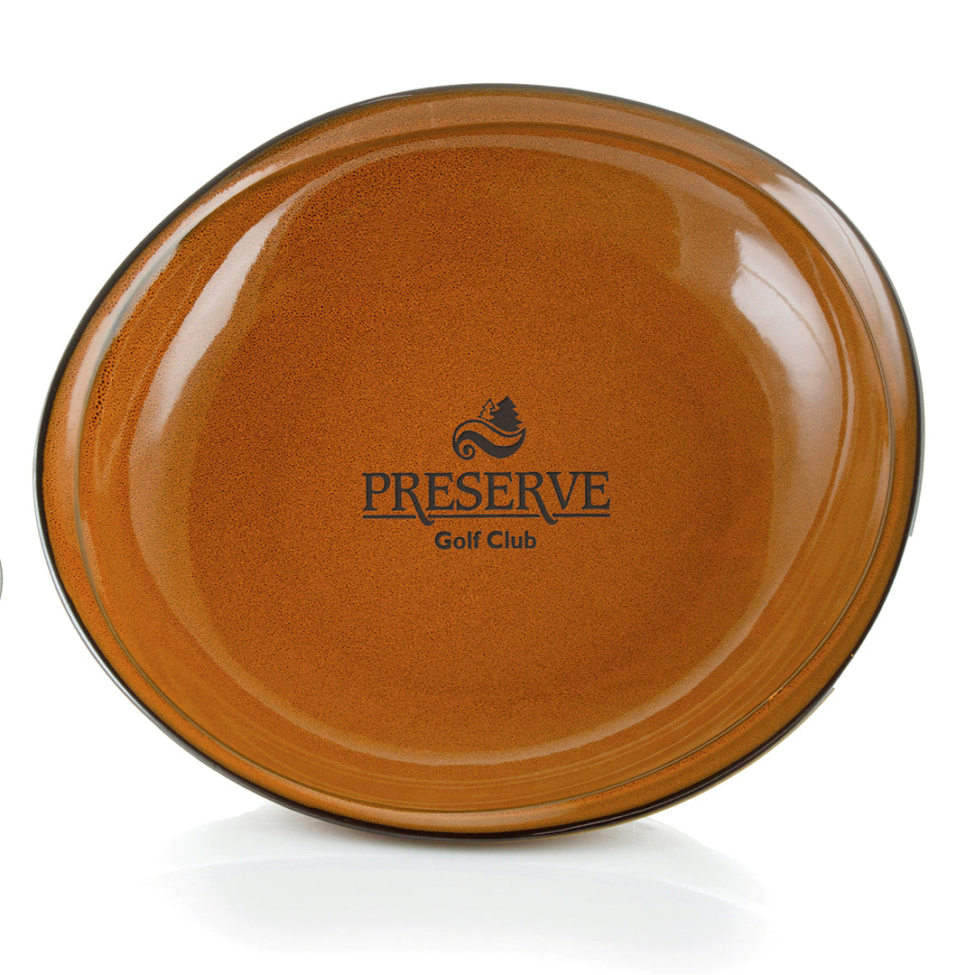 The Prize Possessions Stoneware Terracotta Bowl features a glossy brown finish and The Preserve Golf Club logo in black at the center—a rustic serving bowl perfect for any occasion.