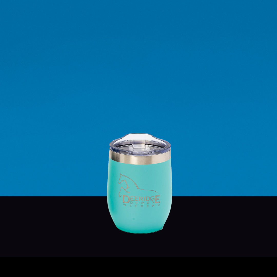 A Prize Possessions Teal Wine Tumbler with a clear lid and silver rim rests on a black surface against a blue background, featuring an outline of a horse and the words "Derridge Weekend" on the front.