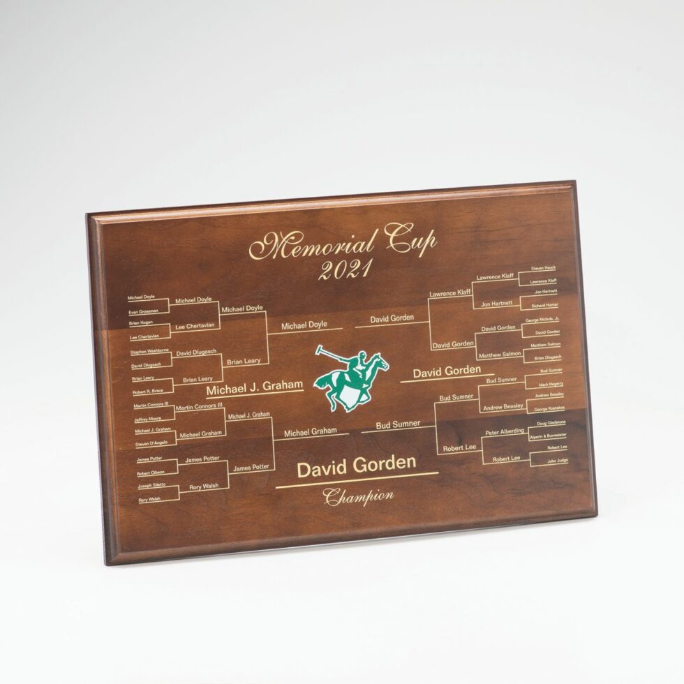 The Prize Possessions Walnut Wood Plaque (Holds 32 Names) showcases a tournament bracket with "Memorial Cup 2021," a gold-engraved champion, other participants' names, and an accent graphic of a polo player for commemorative recognition.