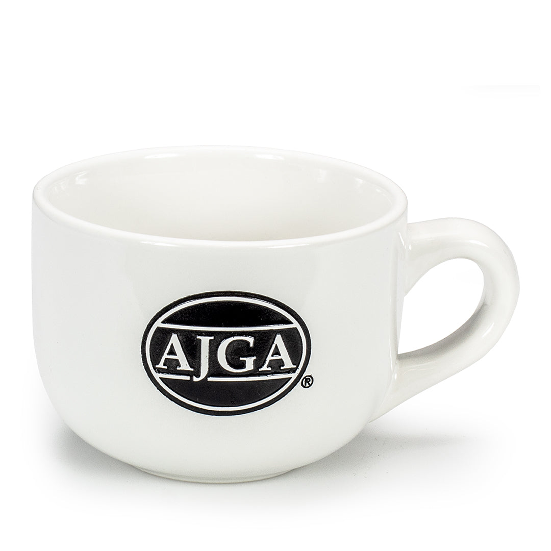 The White Ceramic Latte Mug by Prize Possessions is a classic kitchen essential featuring a handle and a black oval logo with white AJGA letters on its side.