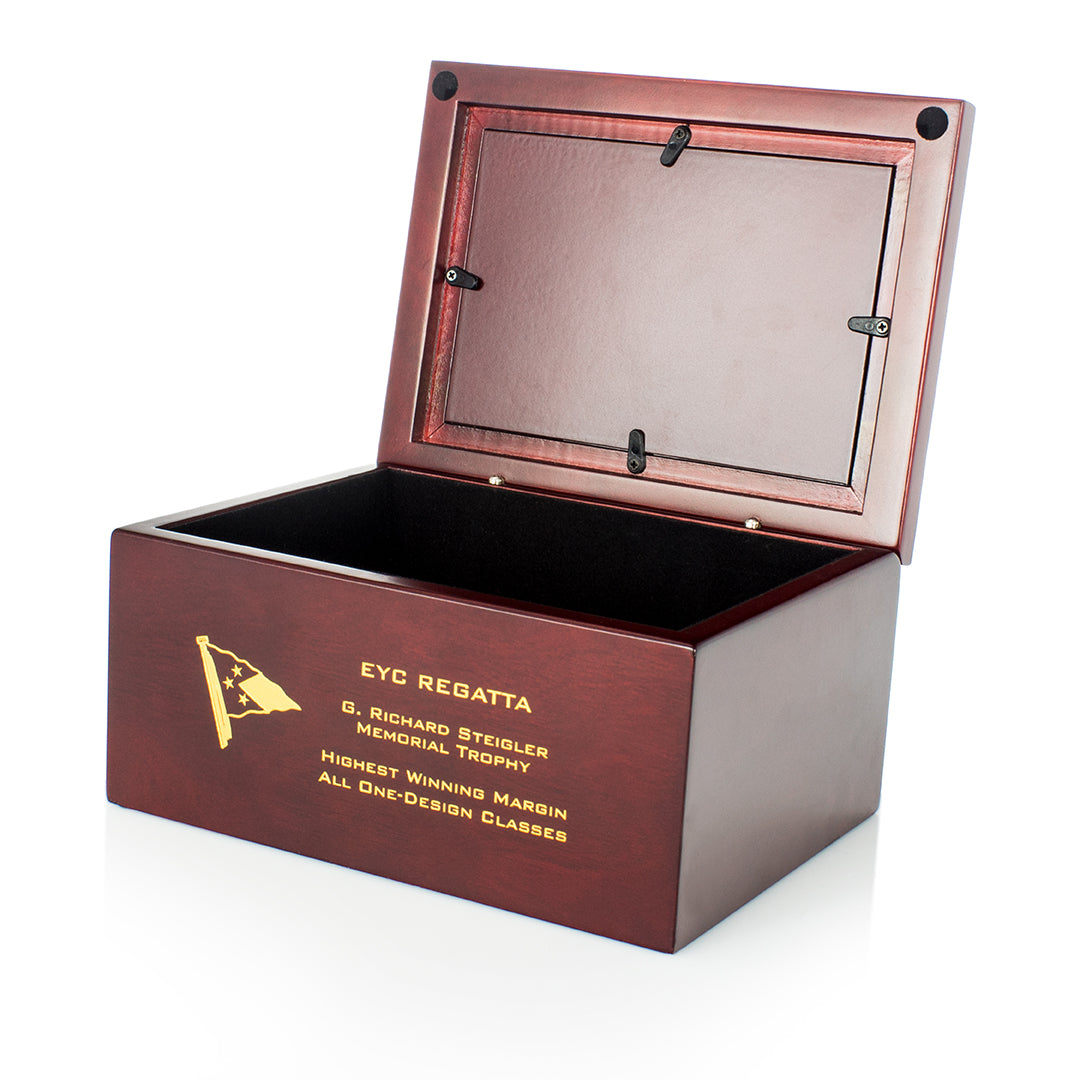 A Prize Possessions Wood Box with a photo insert, hinged lid partially open, engraved with a gold flag and the words "EYC Regatta, G. Richard Steigler Memorial Trophy, Highest Winning Margin, All One-Design Classes.